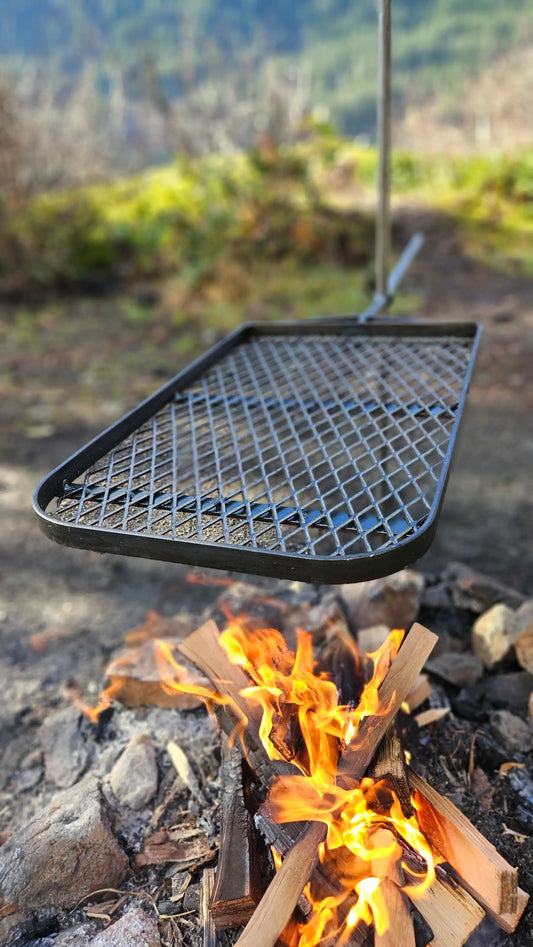 Life Time Anvil Grill Over Fire In A Rock Fire Pit