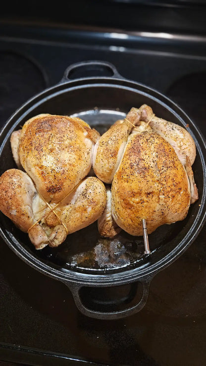 Two roast chickens in cast iron roaster