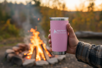 16 oz insulated tumbler held by campfire