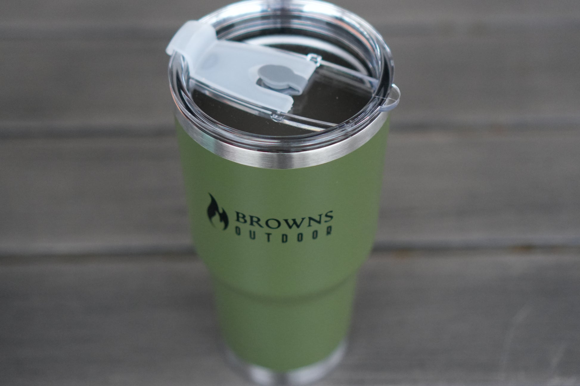 Browns Outdoor Green tumbler with a silver lid on a gray background