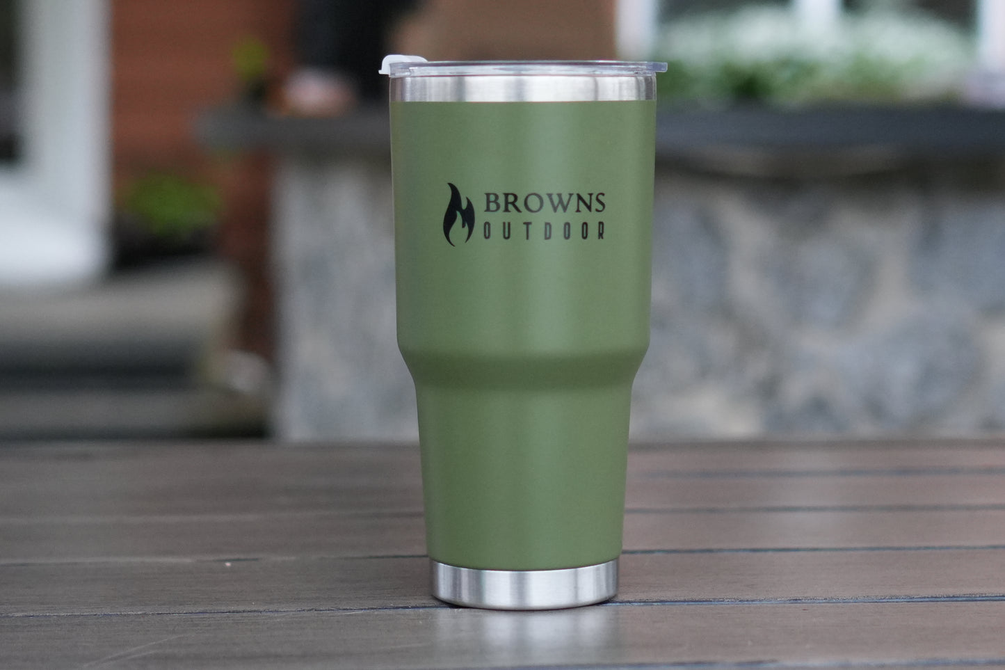Green tumbler with 'Browns Outdoor' logo on a wooden surface