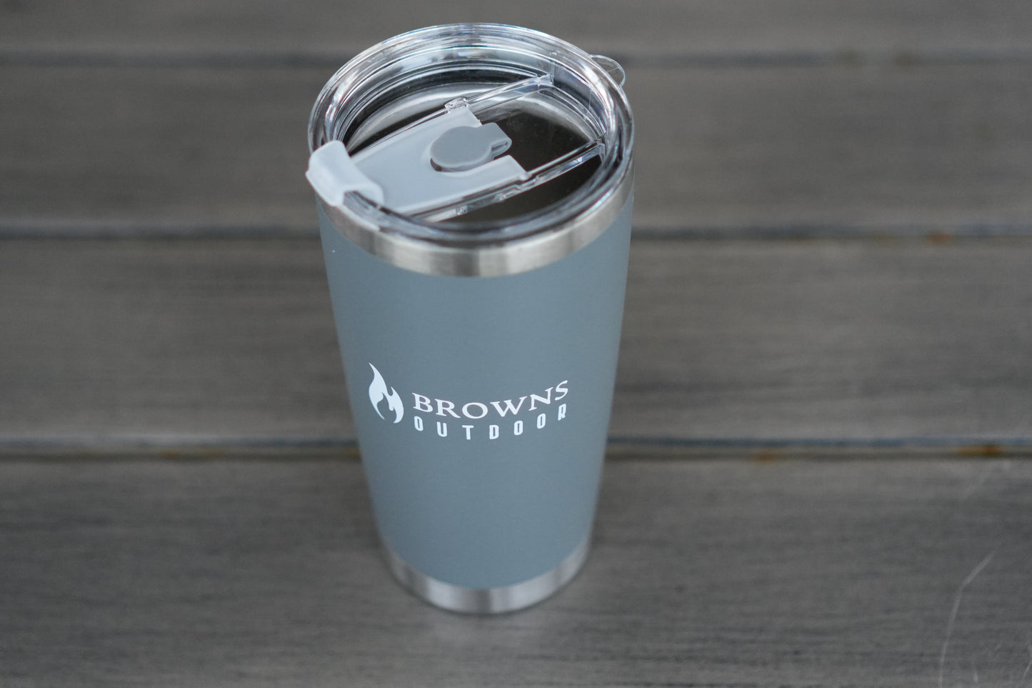 16 oz insulated tumbler in hand wilderness background
