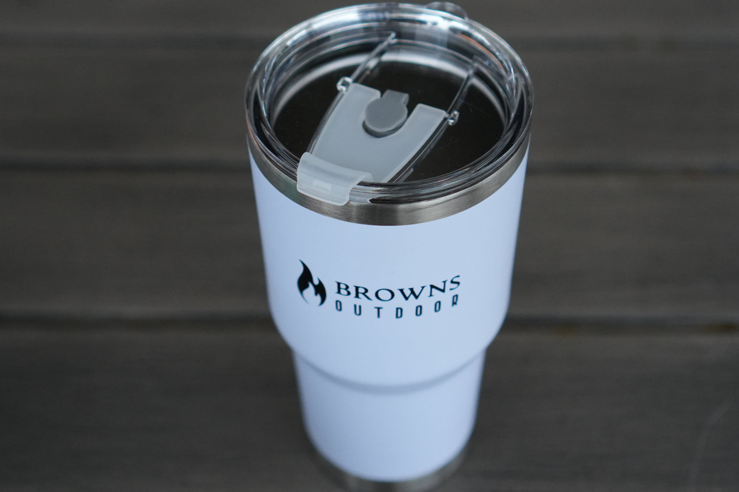 White tumbler with 'Browns Outdoor' logo on a wooden surface