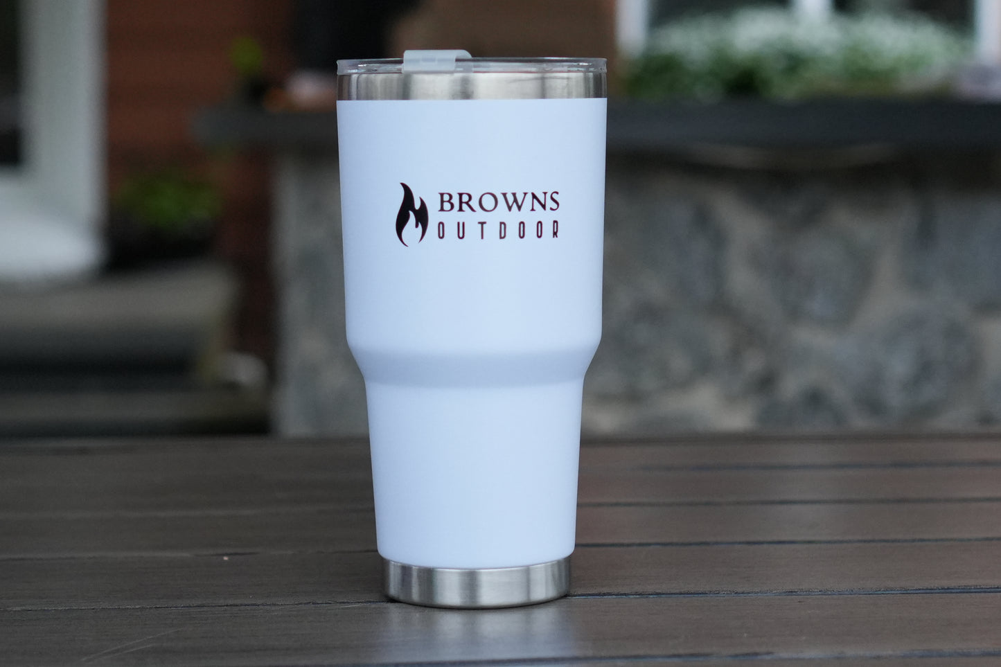 White tumbler with 'Browns Outdoor' logo on a wooden surface